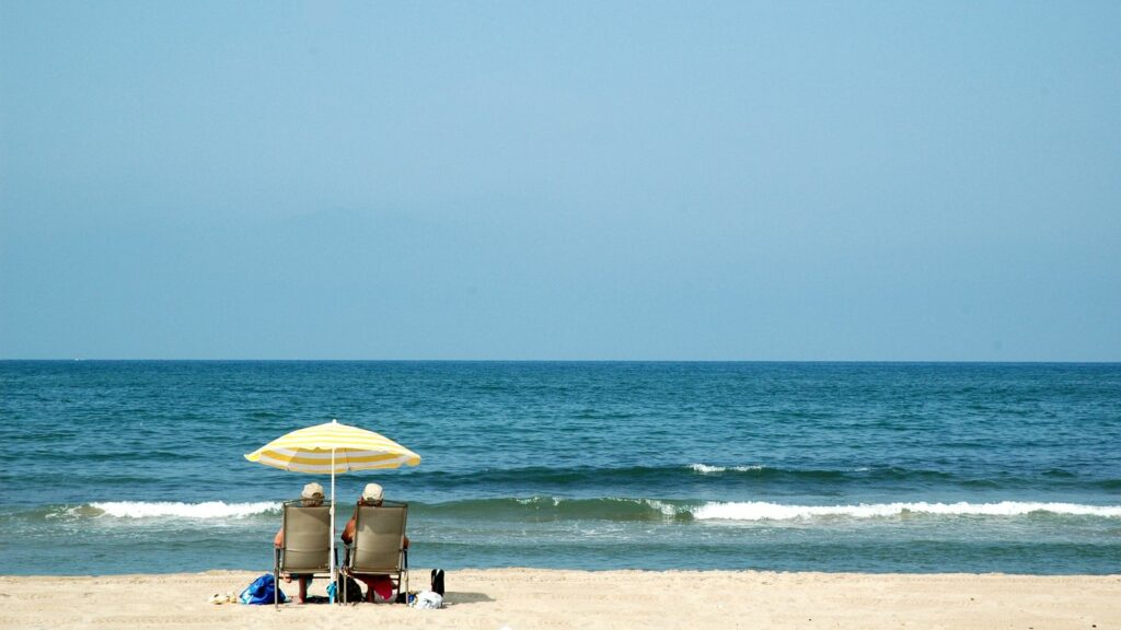 serenity-couple-sitting-in-beach-chairs-watching-the-ocean